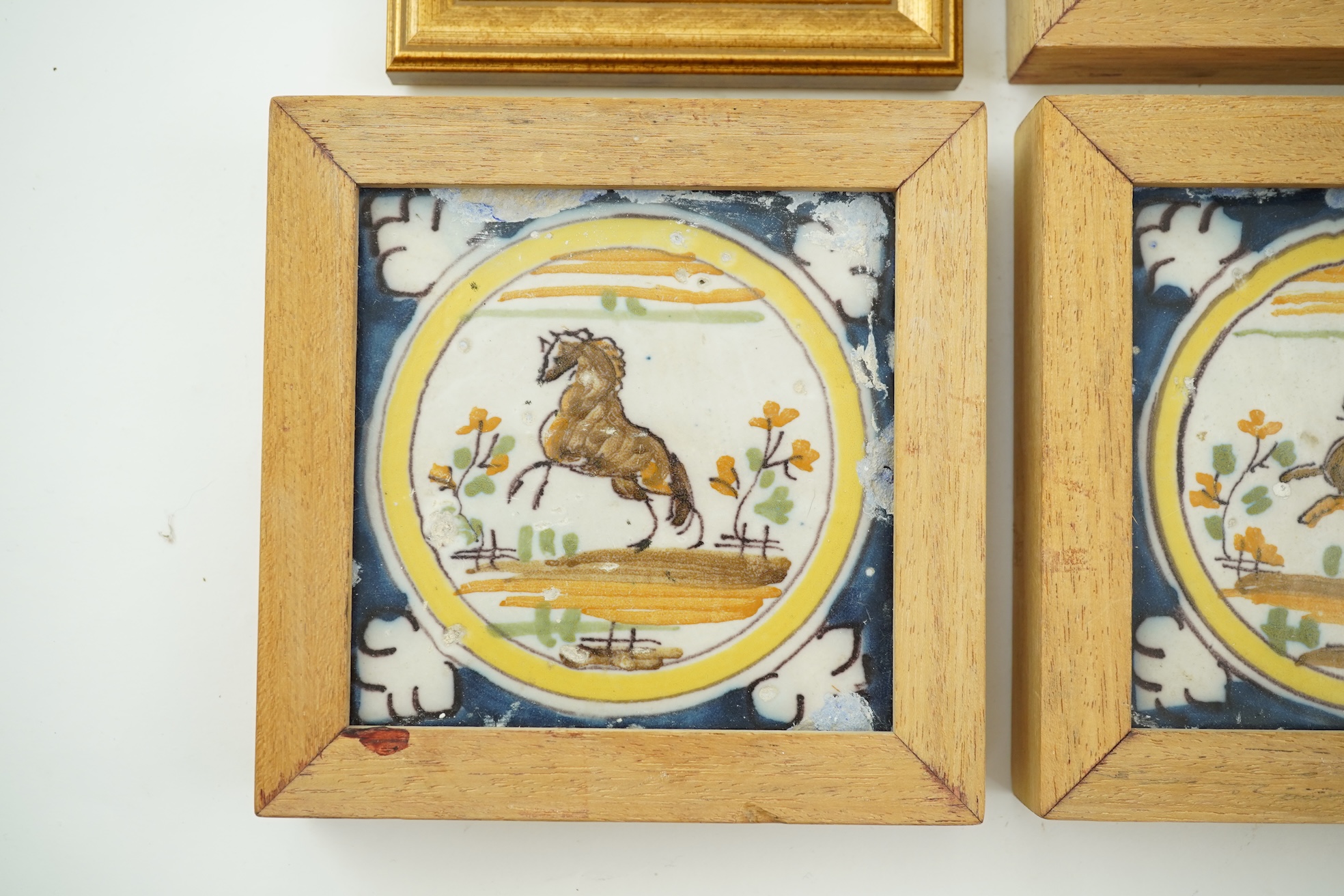 Three Spanish polychrome maiolica ‘animal’ tiles, Triana, early 18th century and a Delft blue and white tile, 19th century